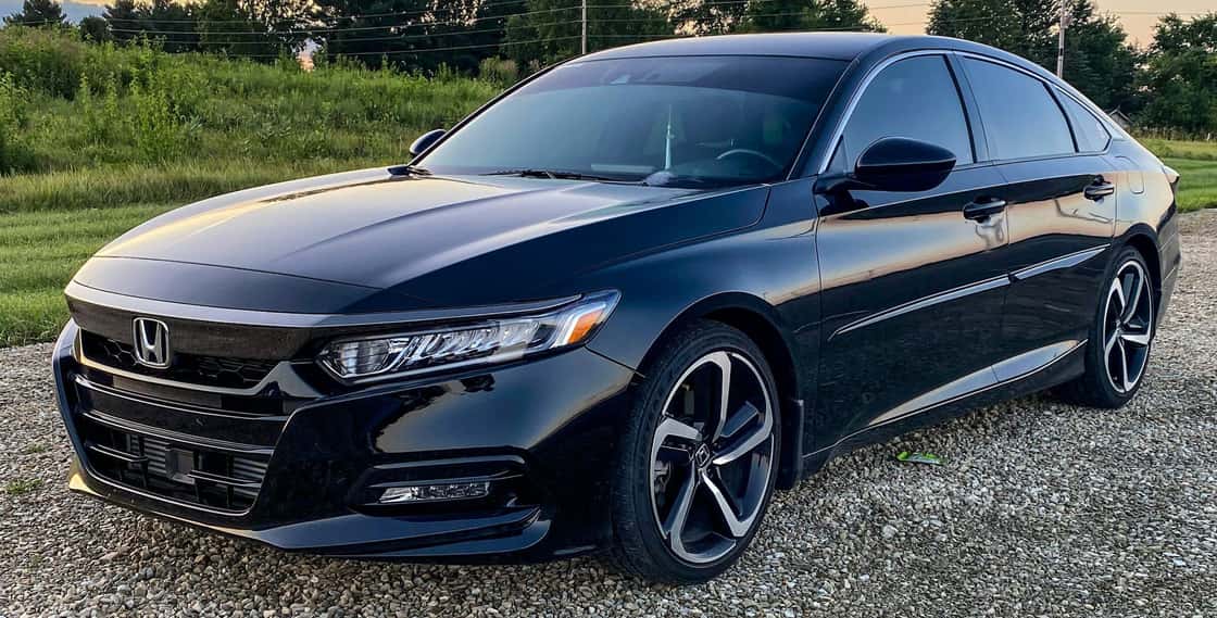 Black Honda sedan parked on gravel lot. Southwest Muffler & Brake, Stafford and Houston.
