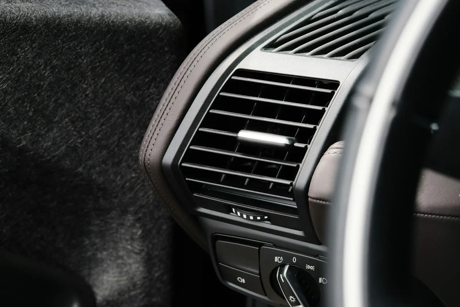 Car interior dashboard air vent and light switch. Southwest Muffler & Brake, Stafford and Houston.