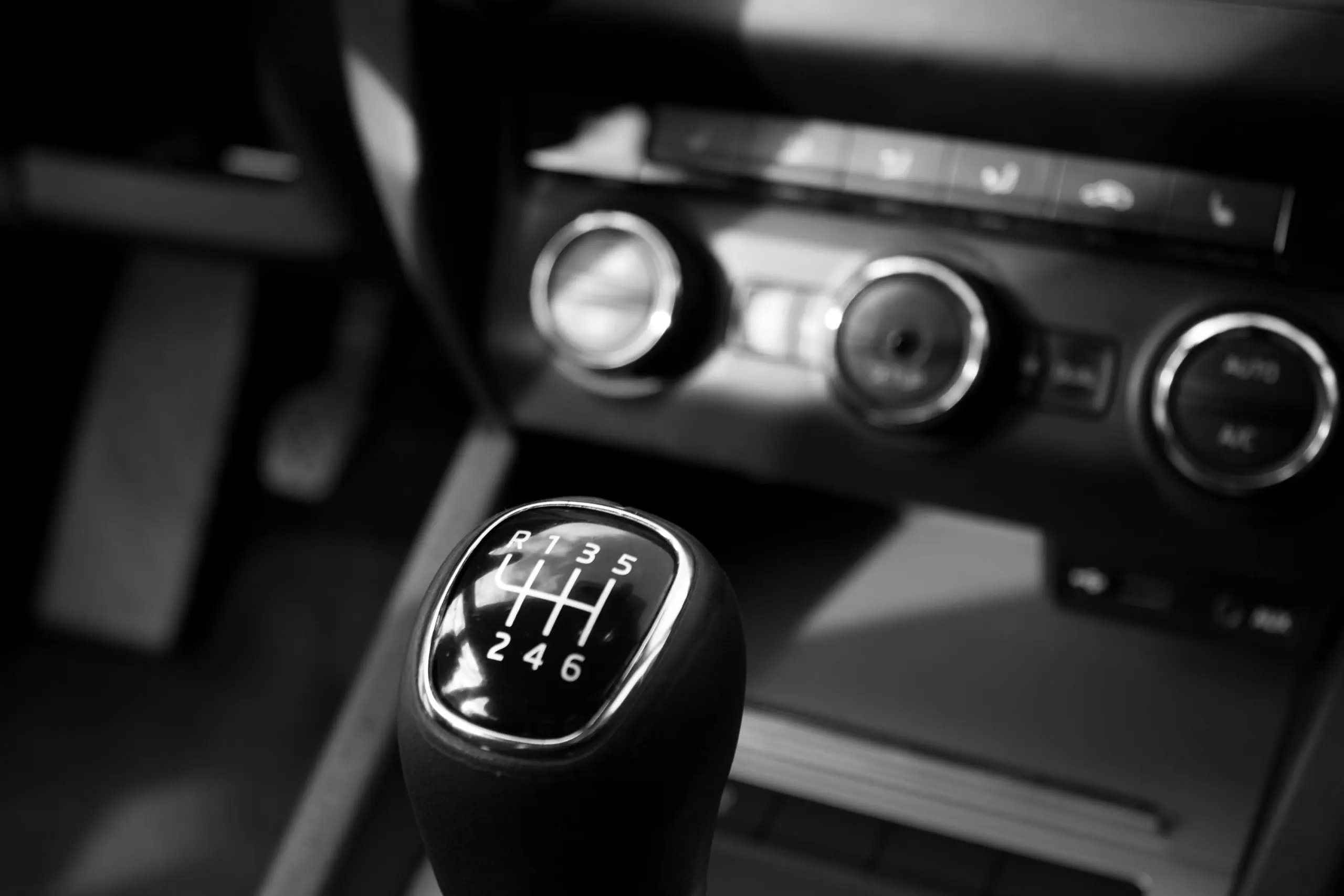 Black and white close-up of manual gear shift. Southwest Muffler & Brake, Stafford and Houston.