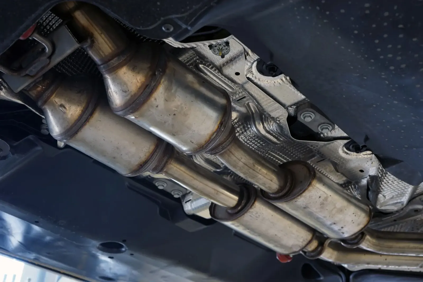 Vehicle undercarriage with catalytic converters and exhaust. Southwest Muffler & Brake, Stafford and Houston.