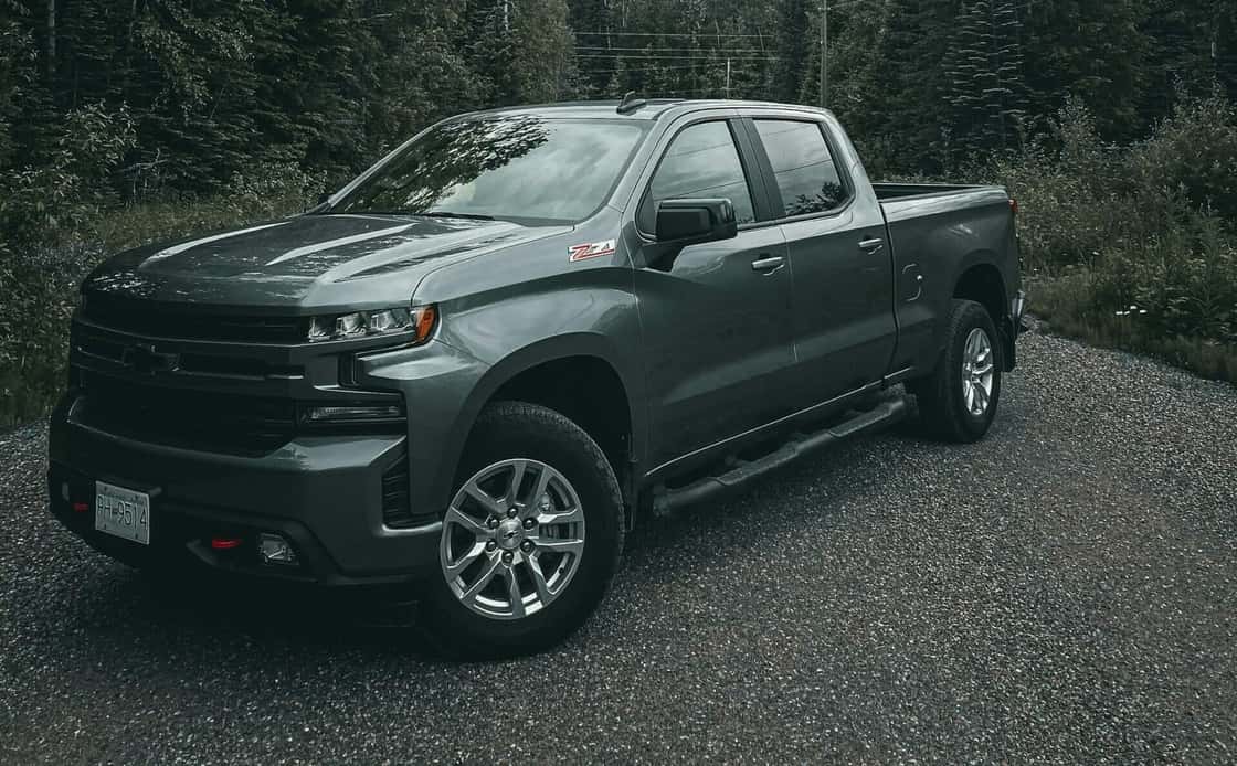 Gray Chevrolet Silverado pickup truck on gravel road. Southwest Muffler & Brake, Stafford and Houston.