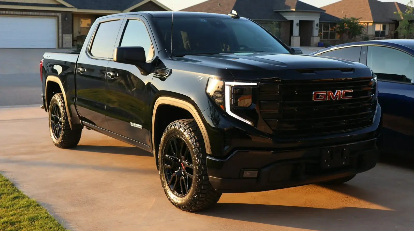 Black GMC pickup truck in residential driveway. Southwest Muffler & Brake, Stafford and Houston.