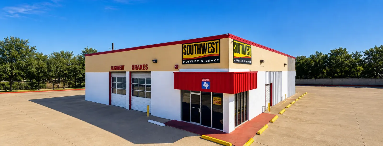 Wide view of Southwest Muffler & Brake on Highway 6 in Houston, with the shop and parking lot.