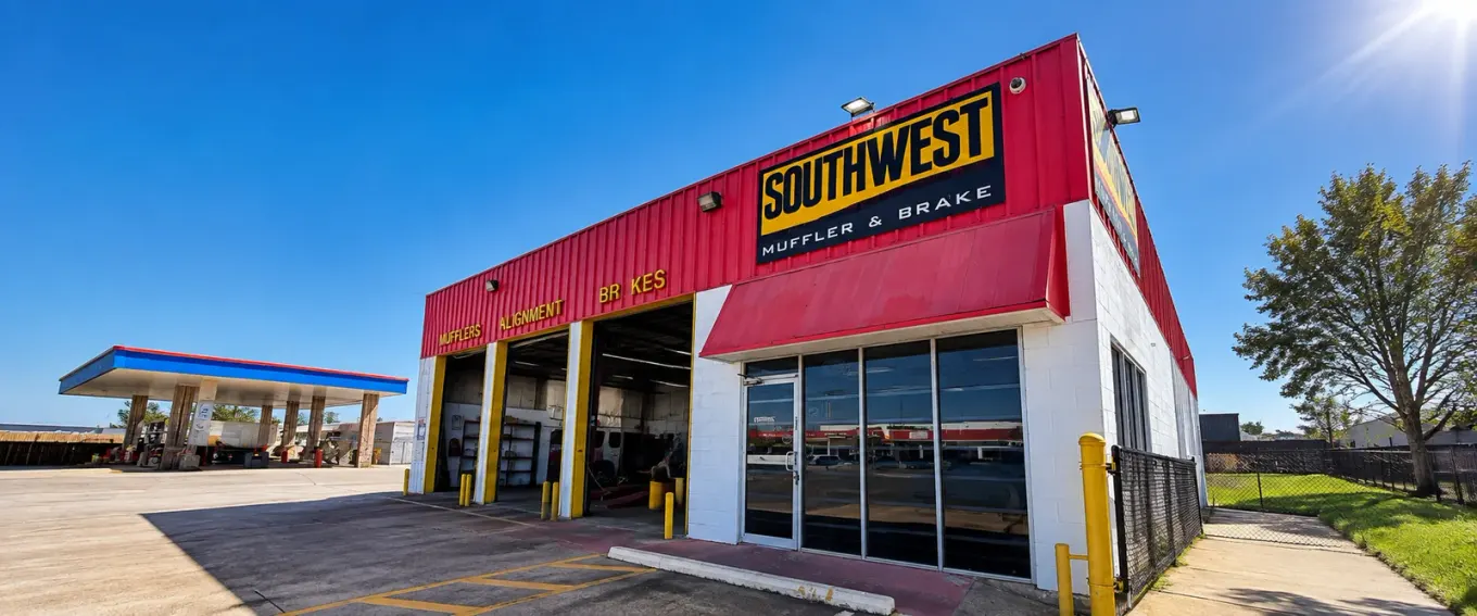 Southwest Muffler & Brake storefront in Stafford, with red trim, shop signs and open service bays.
